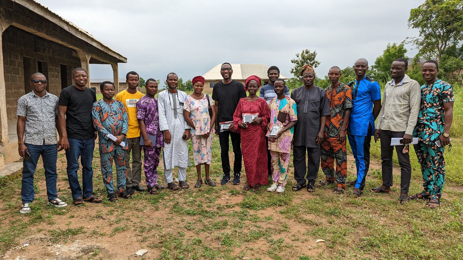 Temitope Odedeyi standing with seventeen farmers and extension staff outside a rural building after a training day
